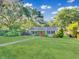 Inviting home with lush green lawn and a vibrant red front door at 1522 Inland Ave, Charleston, SC 29412