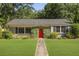 Charming home with a bright red front door and well-maintained lawn at 1522 Inland Ave, Charleston, SC 29412