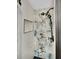 An elegant shower with a black shower head, storage niche, and art deco style tiles at 1522 Inland Ave, Charleston, SC 29412