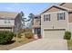 Attractive townhouse featuring neutral siding, attached garage, manicured landscaping, and inviting curb appeal at 153 Wild Holly Dr, Moncks Corner, SC 29461