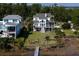 Expansive waterfront property with lush greenery, a private dock, and a grand home perfect for luxury living and outdoor entertainment at 1531 Murphys Island Ct, Awendaw, SC 29429