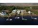 Aerial view of waterfront homes with private docks and lush greenery at 1531 Murphys Island Ct, Awendaw, SC 29429