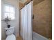 Cozy bathroom with a decorative shower curtain and large window providing natural light at 1531 Murphys Island Ct, Awendaw, SC 29429
