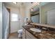 Bright bathroom featuring marble countertops, a sink, a toilet, and a large vanity mirror at 1531 Murphys Island Ct, Awendaw, SC 29429