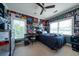 A bedroom with posters, a ceiling fan, and plenty of natural light from large windows at 1531 Murphys Island Ct, Awendaw, SC 29429