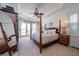 Spacious bedroom featuring a four-poster bed, ceiling fan, and private balcony access with lots of natural light at 1531 Murphys Island Ct, Awendaw, SC 29429