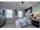 Comfortable bedroom with neutral colors, featuring a bed, dresser, posters, and ambient lighting at 1531 Murphys Island Ct, Awendaw, SC 29429