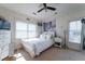 Cozy bedroom with white furnishings, including a bed, dresser, and decorative artwork, bathed in natural light at 1531 Murphys Island Ct, Awendaw, SC 29429