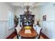 Charming dining room featuring wainscoting, a coffered ceiling and a chandelier above the table at 1531 Murphys Island Ct, Awendaw, SC 29429