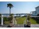 Inviting deck with white railing that provides a picturesque view of the waterway for ultimate relaxation and outdoor enjoyment at 1531 Murphys Island Ct, Awendaw, SC 29429