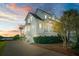 Elegant white home features a two-car garage, a charming balcony and bay window, plus lush landscaping with a view of the river at 1531 Murphys Island Ct, Awendaw, SC 29429