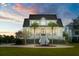Stately two-story white home with palm trees, grand staircase, fountain, and a beautifully landscaped circular driveway at 1531 Murphys Island Ct, Awendaw, SC 29429