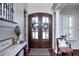 Elegant foyer featuring gorgeous double doors, wood floors, and white trim at 1531 Murphys Island Ct, Awendaw, SC 29429