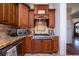 Close-up of the kitchen featuring wood cabinetry, granite countertops, and stainless steel appliances at 1531 Murphys Island Ct, Awendaw, SC 29429
