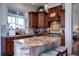Gourmet kitchen featuring custom cabinets, granite counters, and a center island with bar stools at 1531 Murphys Island Ct, Awendaw, SC 29429