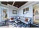 Comfortable screened porch with a dark wood ceiling, and a sectional seating at 1531 Murphys Island Ct, Awendaw, SC 29429