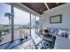 Inviting screened porch with comfortable seating and serene water views at 1531 Murphys Island Ct, Awendaw, SC 29429