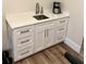 Bright wet bar area with white cabinetry, stainless steel sink, and modern finishes at 1531 Murphys Island Ct, Awendaw, SC 29429