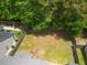 Aerial view of a backyard with a trampoline, a wooden fence and lots of mature trees at 186 Two Pond Loop, Ladson, SC 29456