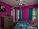 Bright bedroom with pink walls, a ceiling fan, and two windows at 186 Two Pond Loop, Ladson, SC 29456