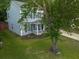 Angle view of a home with a well-maintained lawn, mature tree, and driveway at 186 Two Pond Loop, Ladson, SC 29456