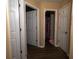 Neutral hallway showcases dark wood floors and access to multiple rooms at 186 Two Pond Loop, Ladson, SC 29456