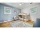 ' bedroom with light blue wall and bunk beds; charming rug and accent chair at 2010 Culver Ave, Charleston, SC 29407