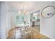 Charming dining area next to the kitchen features a round table, and modern lighting at 2010 Culver Ave, Charleston, SC 29407