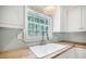 Close-up of a kitchen sink with window and wooden countertop and stylish backsplash at 2010 Culver Ave, Charleston, SC 29407