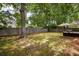 Backyard area featuring outdoor furniture on a patio, an umbrella, trees, and a fence at 2021 Arundel Pl, Mount Pleasant, SC 29464