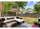 Comfortable backyard featuring patio furniture on a covered area, an umbrella, and trees at 2021 Arundel Pl, Mount Pleasant, SC 29464