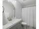 The bathroom features a single vanity, a round mirror, a toilet, and a shower with a white curtain at 2021 Arundel Pl, Mount Pleasant, SC 29464