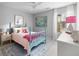Cozy bedroom with charming blue bed, colorful artwork, and abundant natural light at 2021 Arundel Pl, Mount Pleasant, SC 29464