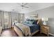 Inviting bedroom with a large window, hardwood floors, a comfortable bed, and soft lighting at 2021 Arundel Pl, Mount Pleasant, SC 29464