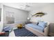 Well-lit bedroom featuring a single bed, a blue patterned rug, and window at 2021 Arundel Pl, Mount Pleasant, SC 29464