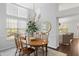 Bright dining room features a wood table, large windows, and stylish light fixture at 2021 Arundel Pl, Mount Pleasant, SC 29464