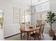 Elegant dining room with wood table, natural light, and stylish decor creates a warm atmosphere at 2021 Arundel Pl, Mount Pleasant, SC 29464