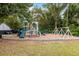 Community playground featuring slides, swings, and climbing structures in a safe, mulched area at 2021 Arundel Pl, Mount Pleasant, SC 29464
