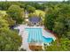 Aerial view of a large community pool with lap lanes and lounge chairs surrounded by mature trees and a clubhouse at 2021 Arundel Pl, Mount Pleasant, SC 29464