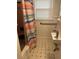 Bathroom featuring a shower/tub combo, white wainscoting, and black and white tiled flooring at 2066 Maybank Hwy, James Island, SC 29412