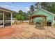 Private backyard with lush greenery, outdoor seating, fire pit, and pergola at 209 Forsythia Ave, Summerville, SC 29483
