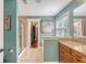 Bathroom with blue walls, granite countertops, tile floors and a glass shower at 209 Forsythia Ave, Summerville, SC 29483
