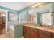 Bright bathroom with granite countertops, blue walls and views of the tub and glass shower at 209 Forsythia Ave, Summerville, SC 29483