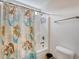 Bright bathroom with a shower featuring a mermaid-themed curtain, and a white toilet at 209 Forsythia Ave, Summerville, SC 29483