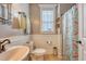 Charming bathroom with beadboard walls, decorative seashell shower curtain, and elegant fixtures at 209 Forsythia Ave, Summerville, SC 29483