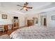Spacious bedroom featuring hardwood floors, neutral colors, ceiling fan, and a large bed at 209 Forsythia Ave, Summerville, SC 29483