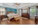This bedroom offers great lighting, hardwood floors, and matching wooden bedroom furniture at 209 Forsythia Ave, Summerville, SC 29483
