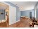 Large bonus room with hardwood floors, blue walls, and a peek into the upstairs hallway at 209 Forsythia Ave, Summerville, SC 29483