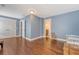 Spacious bonus room with hardwood floors, blue walls, and multiple entryways for flexible use at 209 Forsythia Ave, Summerville, SC 29483