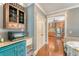 View of butler's pantry with custom cabinets and countertops leading into the kitchen with stainless steel appliances at 209 Forsythia Ave, Summerville, SC 29483